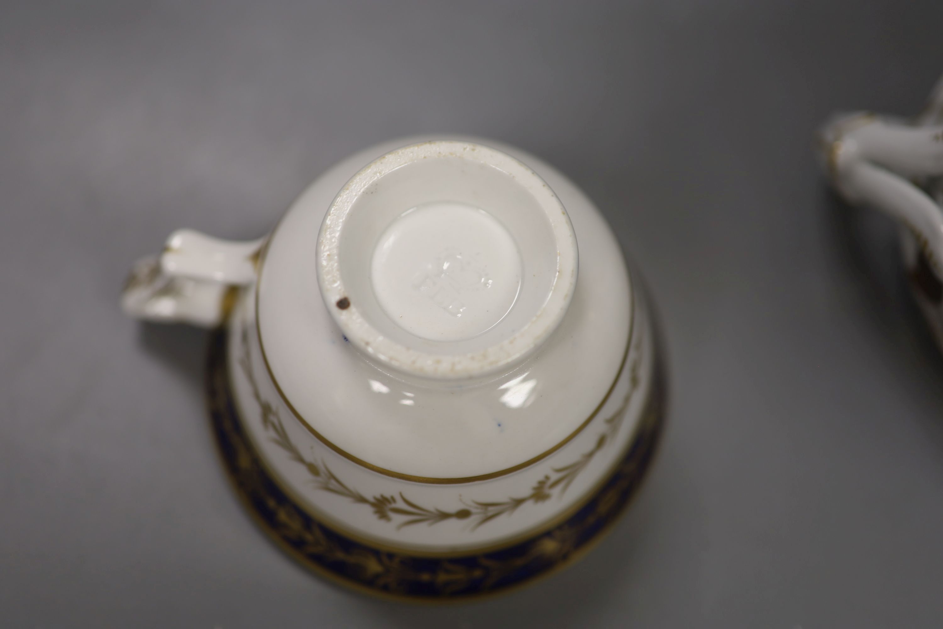 A Flight Barr boat shaped sucrier with brown leaves and gilding above a marbled ground,